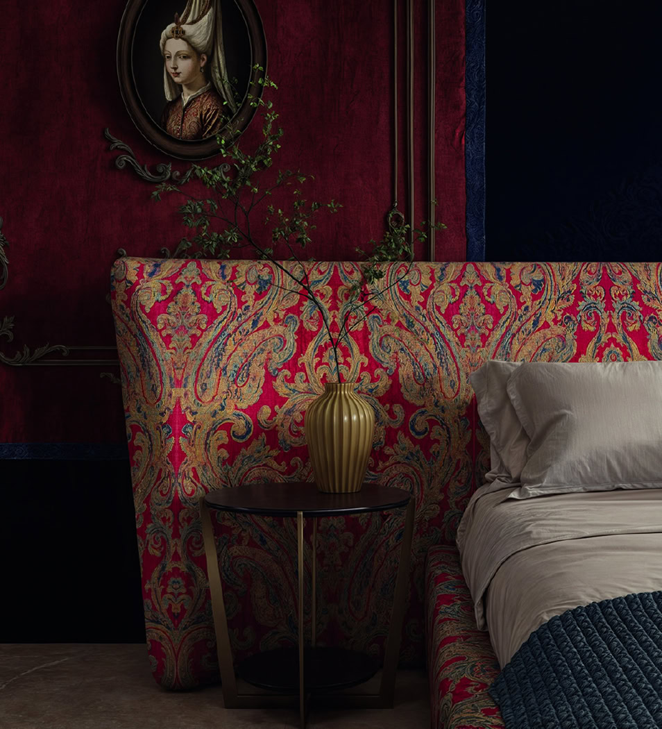 Luxurious upholstered bed with ornate fabric and a matching headboard, complemented by a stylish side table and decorative elements in a sophisticated bedroom.