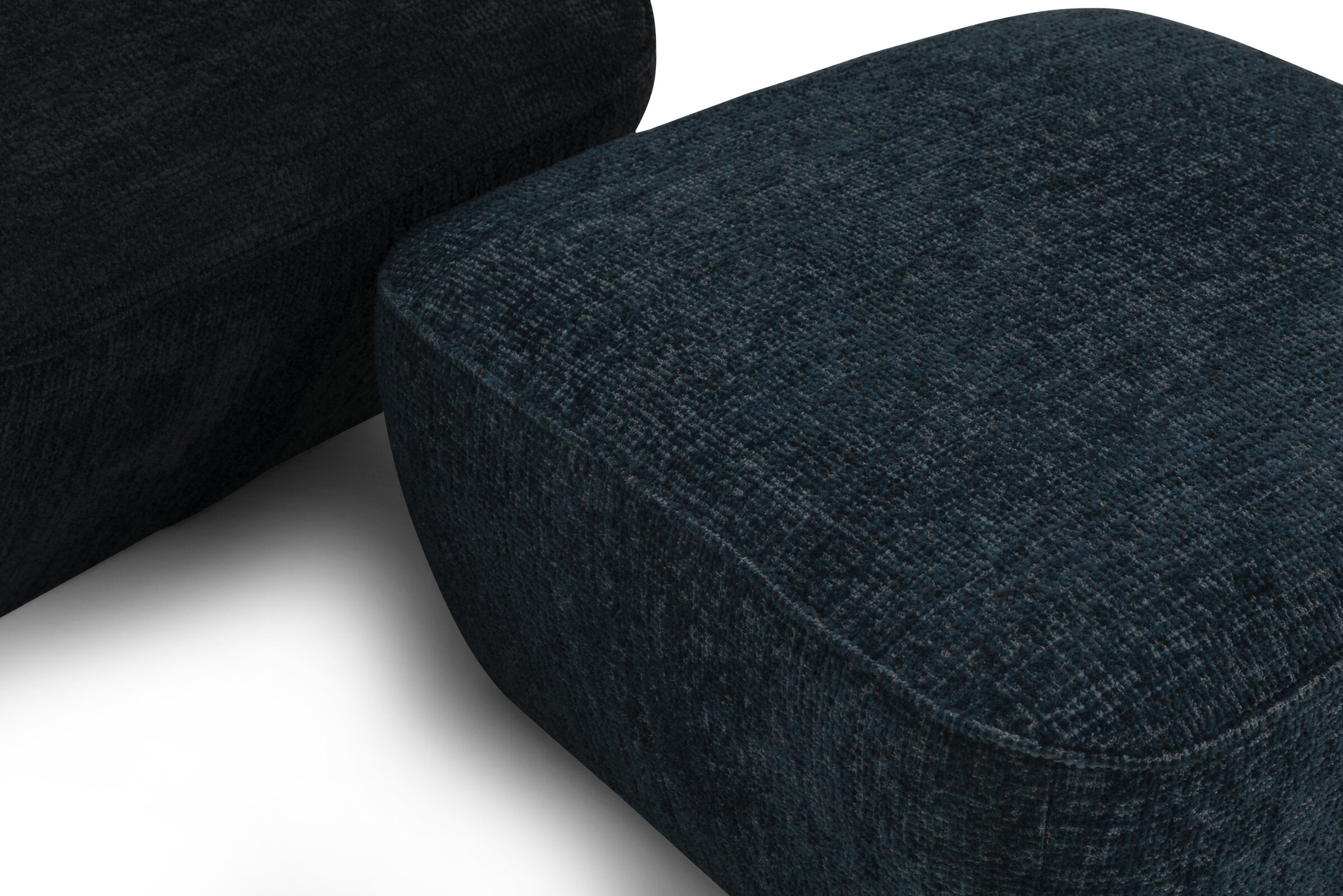 Soft upholstered dark blue fabric sectional sofa with rounded edges and textured finish, perfect for modern living room furniture.