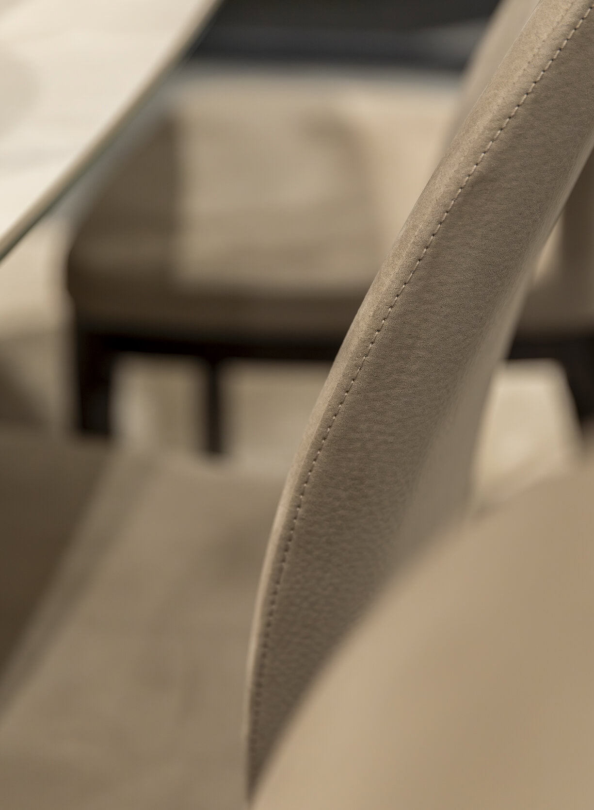Soft beige upholstered chair with detailed stitching, showcasing modern furniture design and quality materials for elegant home or office decor.