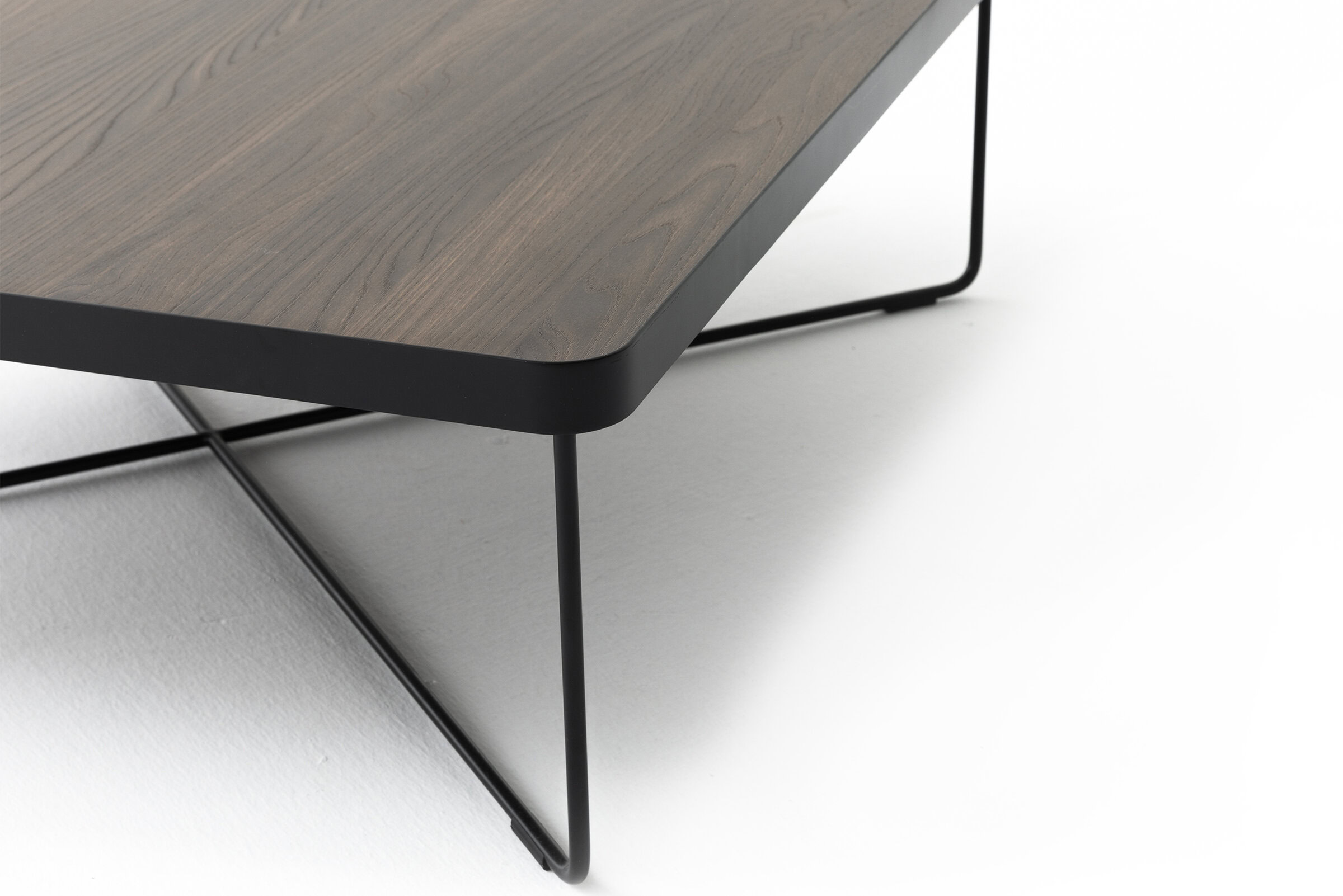 Sleek modern coffee table with a wood finish and black metal frame, perfect for contemporary home decor.