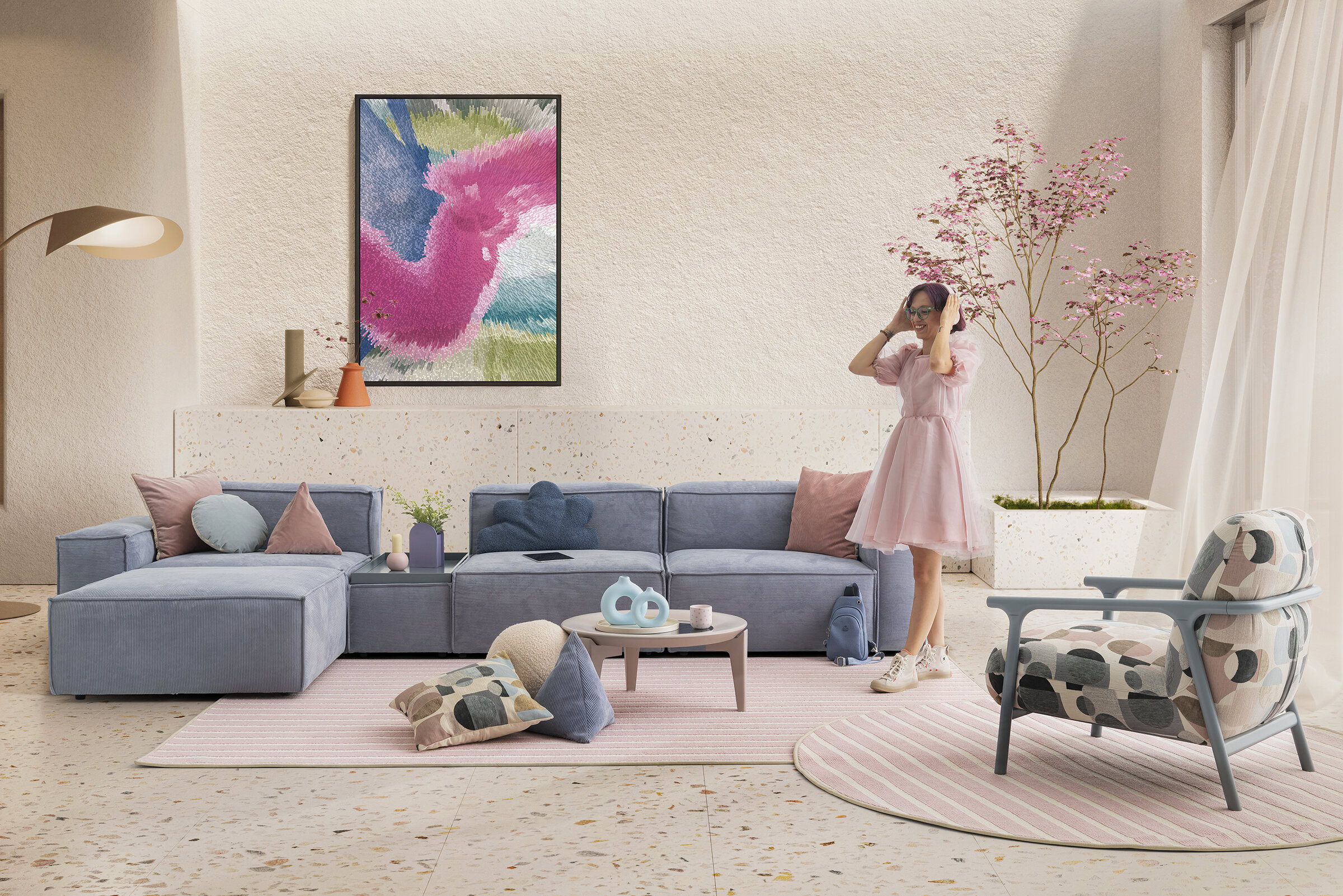 Stylish living room with pastel blue sofa, pink cushions, and modern decor, perfect for relaxing or entertaining. The space includes a woman enjoying virtual reality, highlighting comfort and innovati.