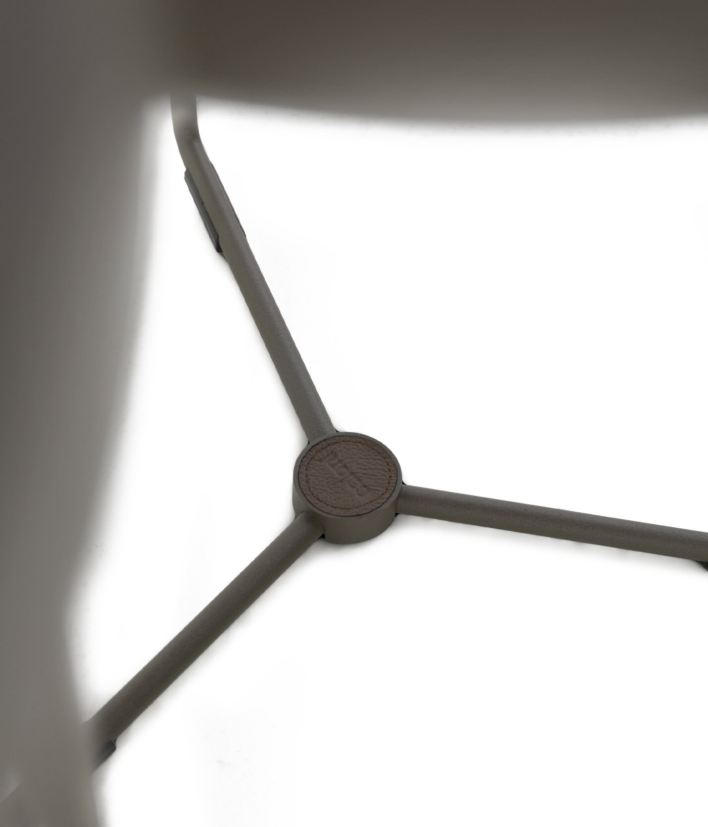 Elegant metal furniture leg with a leather accent, showcasing modern design and high-quality materials.