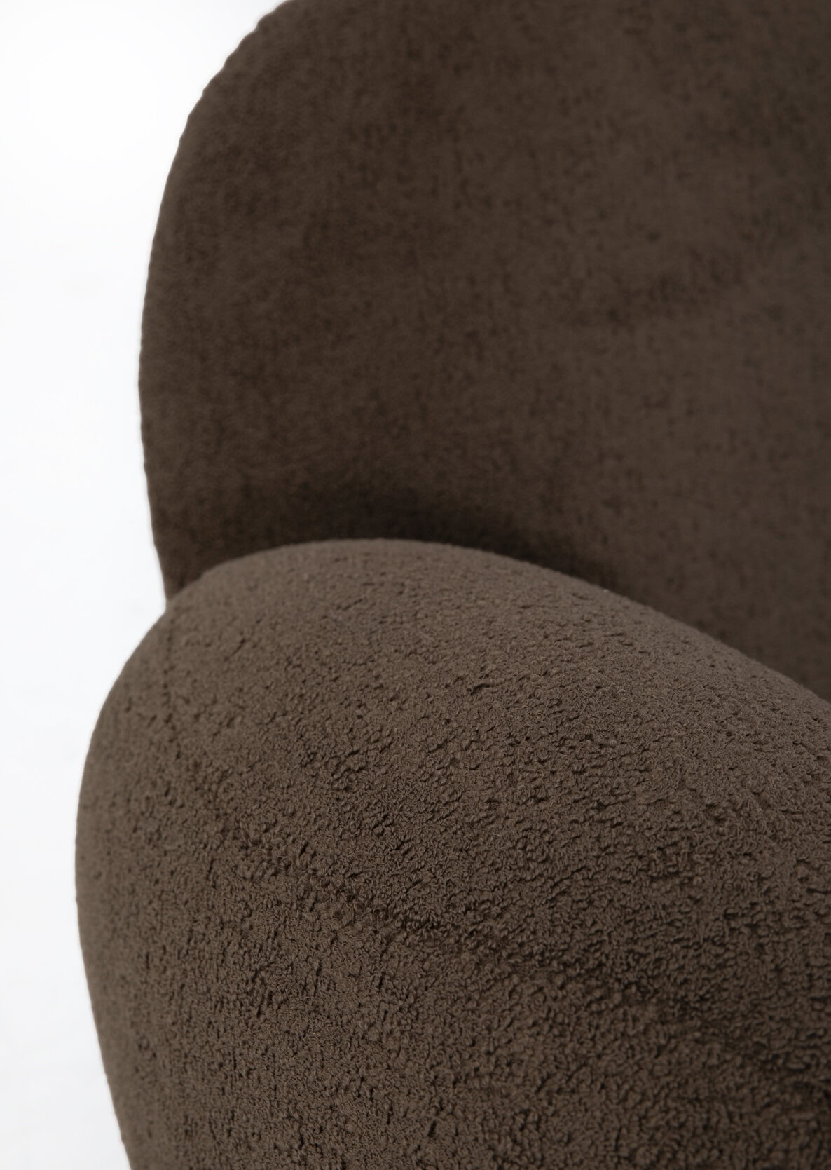 Soft, plush brown upholstered armchair with textured fabric, perfect for modern living rooms and cozy spaces, showcasing elegant furniture design from Saloni Furniture.