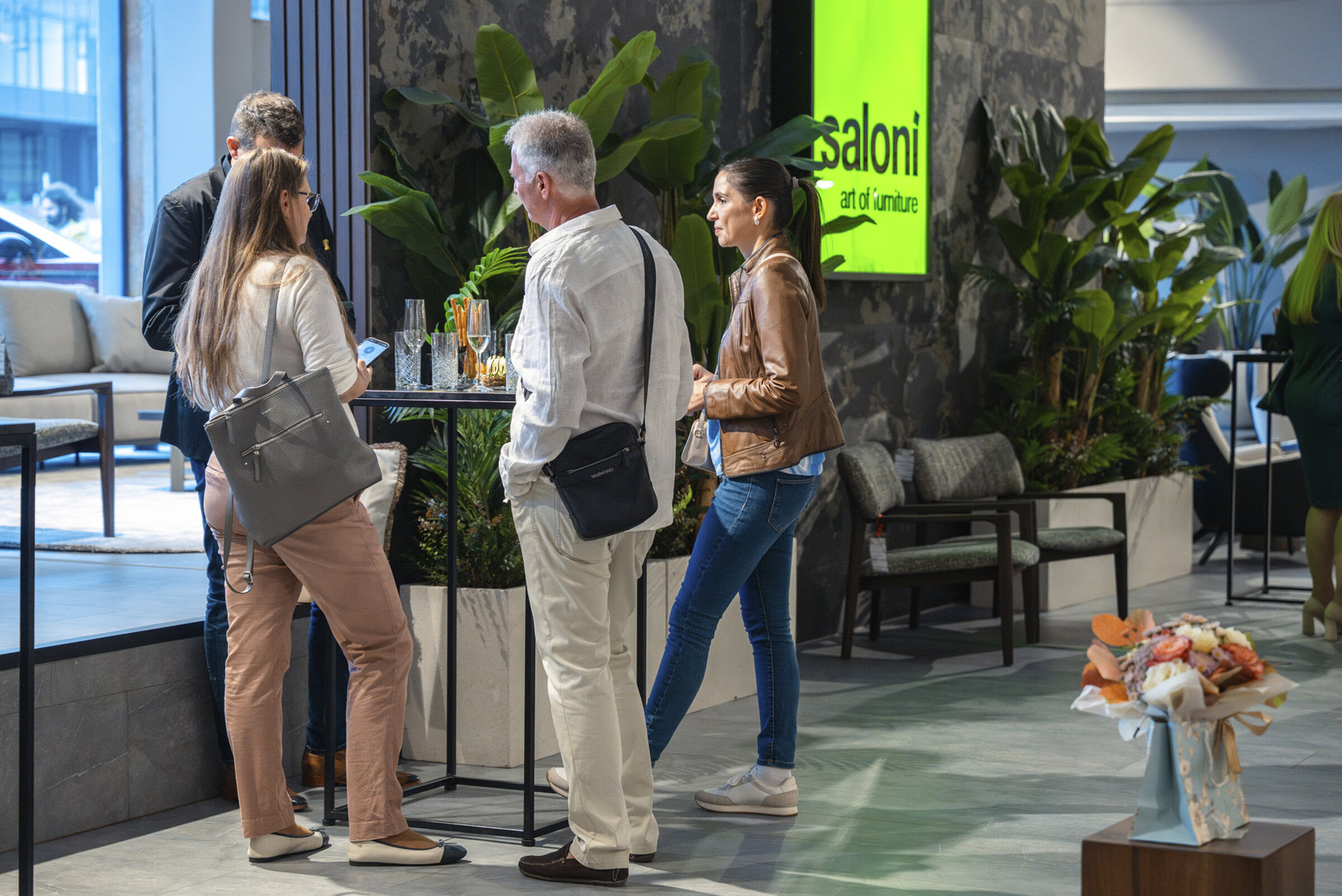 Modern furniture showroom display with customers exploring stylish home furniture and decor at Saloni Furniture.