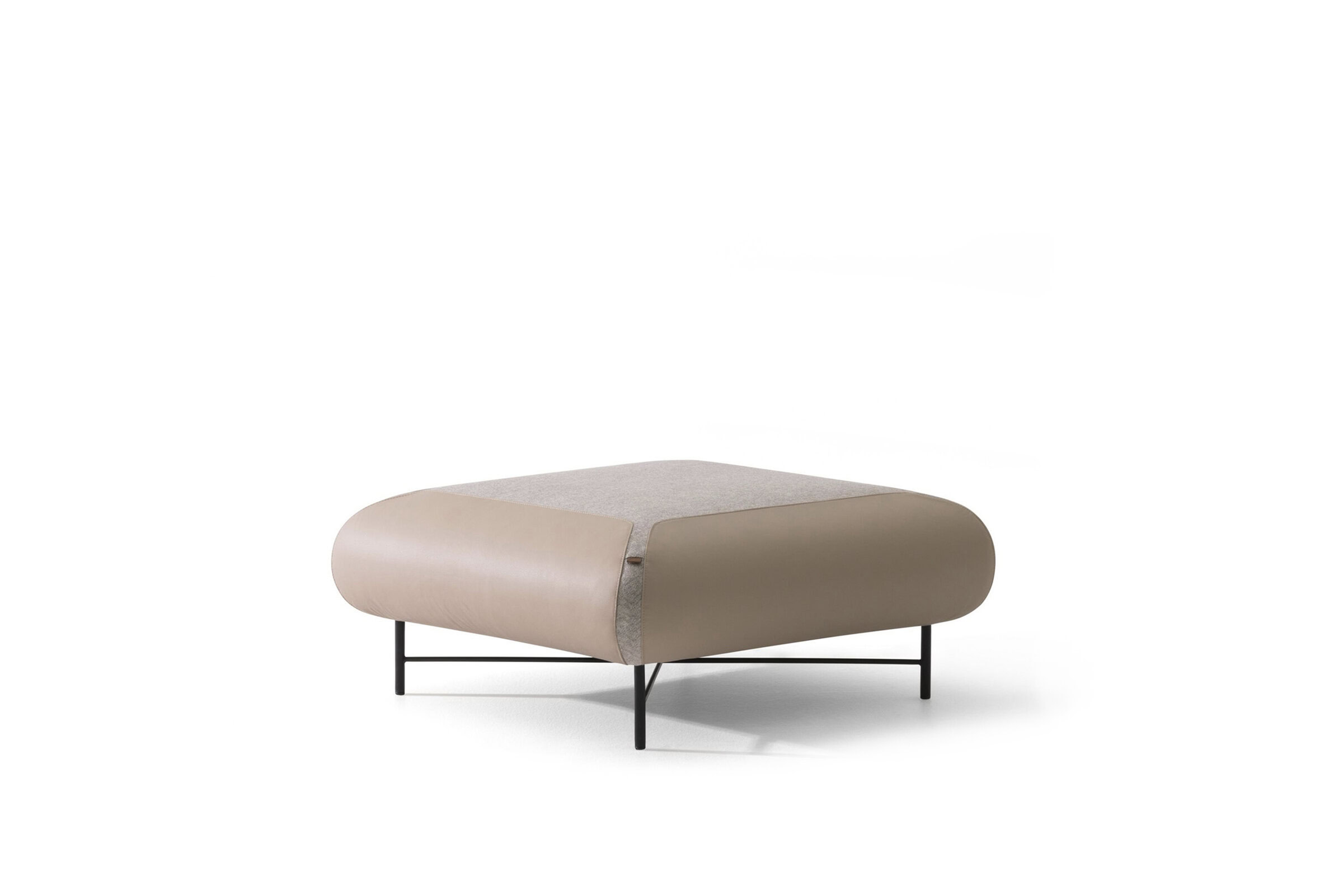 Contemporary modern beige and taupe upholstered lounge ottoman with sleek black metal legs, designed for stylish living room furniture and versatile seating options.