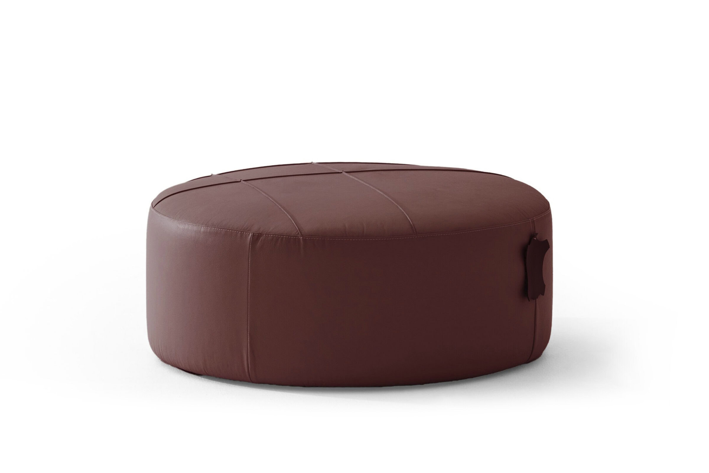 Luxurious burgundy leather ottoman with a smooth, rounded design and stylish stitched details, perfect for modern living room decor and comfortable seating.