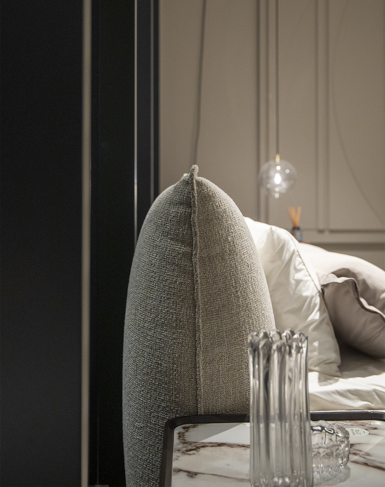 Luxurious upholstered bed headboard with soft beige fabric, modern stylish bedroom furniture, creating a cozy and elegant bedroom setting.